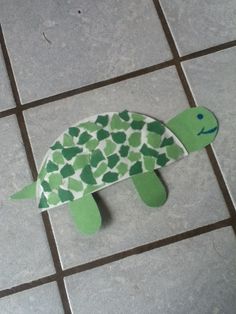 a paper cut out of a turtle on the ground