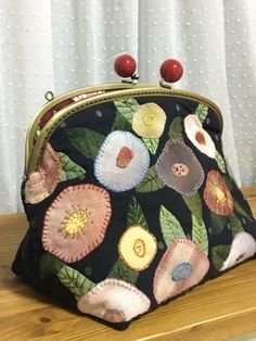 a purse sitting on top of a wooden table