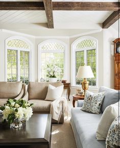 a living room filled with furniture and windows