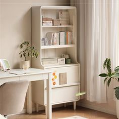 a white desk and chair in front of a book shelf with books on it next to a potted plant