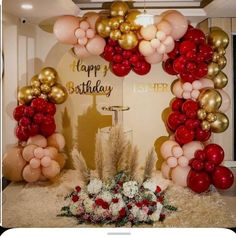 a birthday party with balloons and flowers