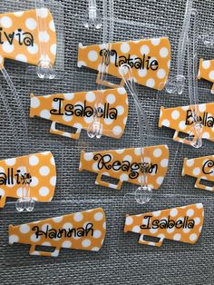 orange and white polka dot name tags with plastic clips