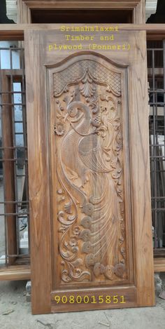 an intricate carved wooden door in the shape of a peacock