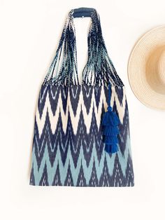 A stylish tote bag that has plenty of room to hold everything you need for a day at the beach, the farmer's market or as everyday tote. From your towel to sunscreen and wallet, you can carry all of your beach essentials. This bag is crafted from textured cotton canvas fabric. These bags are handwoven by skilled artisans in Momostenango, Guatemala on traditional backstrap looms. Madre Luna recognizes the importance of heritage, high quality and craftsmanship. We partner with cooperatives, small a Summer Cotton Shoulder Bag For Travel, Vacation Cotton Shoulder Bag With Adjustable Strap, Handmade Beach Bag For Travel During Beach Season, Bohemian Beach Bag For Beach Season Travel, Bohemian Beach Bag For Travel And Beach Season, Cotton Shoulder Bag For Daily Use At Beach Season, Bohemian Beach Bag For Travel During Beach Season, Cotton Beach Bags For Daily Use, Summer Tote Hobo Bag With Adjustable Strap