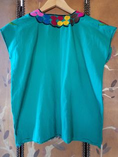 "70s lovely bright emerald green blouse with bright embroidery Black stitching at cuffs and around the V- neck Bust across 21\" (42\" around) Length 23\" Across shoulders 21\" Arm openings 16\" around **a couple of very light blue Mark's on left side. Little mend at bottom left side" Green Floral Embroidered Crew Neck Blouse, Green Embroidered Crew Neck Blouse, Green Crew Neck Blouse With Floral Embroidery, Green Long Sleeve Embroidered Cotton Top, Green Cotton Top With Floral Embroidery, Bohemian Green Top With Embroidered Hem, Bohemian Green Embroidered Hem Top, Folk Style Green Embroidered Top For Spring, Green Summer Blouse With Embroidered Hem