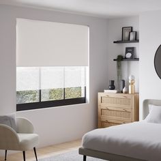 a bedroom with a bed, chair and large window in it's center area