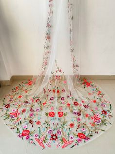 a white veil with flowers and vines on it