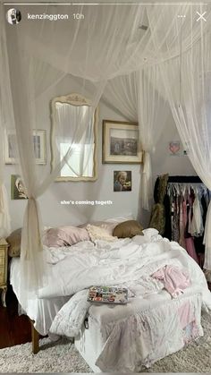 a white bed sitting in a bedroom next to a window