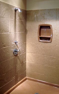 a bathroom with a soap dispenser on the wall