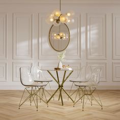 an elegant dining room with white walls and wood flooring, round glass table surrounded by clear chairs