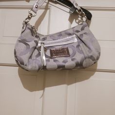 Coach Bag Poppy Collection Gray And Silver Sparkle Fleck Signature C Pattern Never Used The Front Has The Leather Logo In Silver Of Coach Poppy Collection As Well As The Front Pocket Zipper Pull Tab. There Are Also Logo Tags Hanging From The Handle. The Inside Is Mauve Pink With A Traditional Back Zipper. Excellent Condition And Smoke Free Home, Dr71523 Coach Poppy Bag, Silver Crossbody Bag With Handle Drop, Silver Designer Shoulder Bag With Detachable Strap, Designer Silver Bag With Detachable Strap, Designer Silver Bags With Silver-tone Hardware, Designer Silver Shoulder Bag With Palladium Hardware, Silver Coach Shoulder Bag With Handles, Coach Gray Shoulder Bag With Silver-tone Hardware, Silver Shoulder Bag With Palladium Hardware