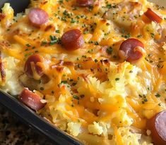 a casserole dish with sausage, potatoes and cheese