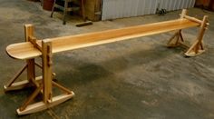 a wooden bench sitting on top of a cement floor