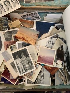 an old box filled with pictures and papers