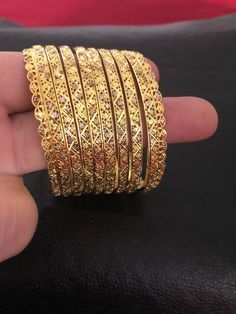 Intricate and classic. Pure silver 92.5 bangles! The details worth falling for❤️ A pure handcrafted and 24 KT gold plating over pure silver 92.5 bangles set, this festive season. Love these creations!! Absolutely stunning Bangles set : 8 piece Bangles set included: 6 bangles and two kadas Size : 2.6 Silver weight: 80.00 Garam and 200.00 milligrams Can be customize in any size. Made to order and shipping time 4-6 weeks. Wedding Filigree Bangle Jewelry, Handmade Elegant Bangle For Diwali, Traditional Bangle For Anniversary, Traditional Heavy Bangle For Anniversary, Traditional Bracelets For Anniversary And Festivals, Elegant Handmade Bangle For Diwali, Elegant Handmade Diwali Bangle, Traditional Anniversary Bangle, Heavy Round Bangle For Anniversary