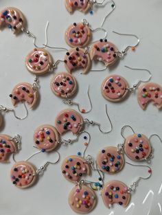 These delightful cookie earrings are a playful accessory for any dessert lover! Crafted to resemble freshly baked cookies, each earring features a charming pink frosting that's drizzled to perfection and adorned with colorful rainbow sprinkles. Lightweight and comfortable to wear, they're made from a high-quality polymer clay. Perfect for adding a touch of whimsy to your outfit or gifting to a friend who adores all things sweet. Treat yourself or someone special to these fun, eye-catching earrings that are sure to spark joy! Cookie Earrings, Two Peas In A Pod, Pink Frosting, Baked Cookies, Peas In A Pod, Dessert Lover, Rainbow Sprinkles, Spark Joy, Colorful Rainbow