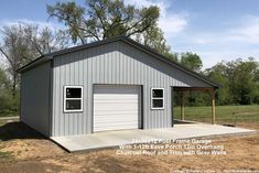 a two car garage in the middle of a field