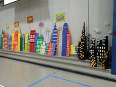 an indoor bowling alley with brightly colored cityscapes on the wall