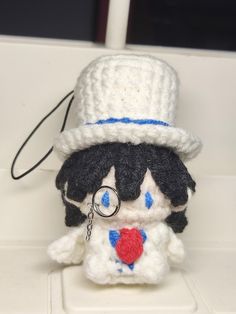 a small stuffed animal with a hat on it's head and eyeglasses