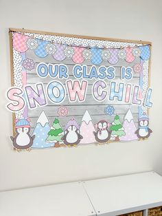 a sign that says our class is snow chill with penguins and trees on the front