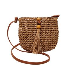 a straw bag with tassels and a wooden bead on the front strap