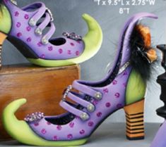 a pair of purple shoes with spikes on them