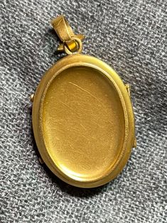 ". This beautiful oval locket has that gorgeous Victorian \"bloom\" to the gold that cannot be duplicated. It really can't be duplicated because the process has been illegal for almost 100 years now. The bale is an abstract fleur de lis shape. This locket is plated in 18k, thick enough to test 18k on the electronic tester! This locket does not have removable photo rings, but a printed picture could be carefully pressed in so it sits under the edge. I just print from my home printer on photo pape Luxury Yellow Gold Oval Locket Necklace, Luxury Oval Locket Necklace As Gift, Luxury Oval Jewelry For Keepsake, Antique Oval Jewelry With Polished Finish, Elegant Oval 14k Gold Locket Necklace, Elegant 14k Gold Oval Locket Necklace, Heirloom Oval Engraved Locket Necklace, Yellow Gold Oval Pendant Locket Necklace For Memorial, Classic Oval Locket Necklace Stamped 14k