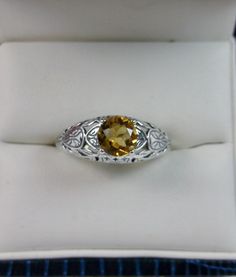 Natural Yellow Citrine Ring Description Etched Wedding Design#160 MADE TO ORDER Here we have a Victorian/Edwardian reproduction ring in sterling silver with a stunning natural yellow citrine gemstone. This full cut round cut .52ct genuine citrine is 6mm in diameter. The inside of the band is marked 925 for sterling. Notice the beautiful floral design of the silver filigree setting and band. This is a lovely rendition of an Antique filigree ring, and it is ready to wear. A gift ring box is includ Traditional Oval Filigree Wedding Ring, Hallmarked Round Cut Topaz Wedding Ring, Classic Citrine Rings For Wedding, White Gold Citrine Topaz Wedding Ring, Wedding Hallmarked Round Cut Topaz Ring, Classic Citrine Wedding Rings, Heirloom Topaz Ring With Intricate Design For Anniversary, Diamond Filigree Ring With Gemstone For Wedding, Citrine Center Stone Wedding Jewelry