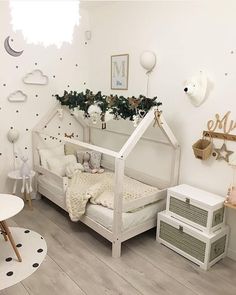 a child's bedroom with white furniture and decorations