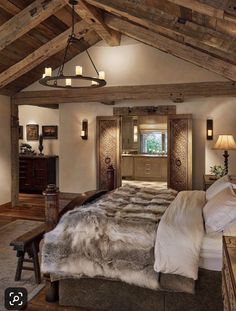 a large bed sitting inside of a bedroom next to a wooden ceiling