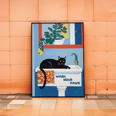 a black cat sitting on top of a sink in front of a wall with a potted plant