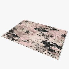 an area rug with black and pink paint splattered on it's surface