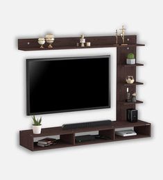 a flat screen tv mounted on top of a wooden entertainment center next to a plant