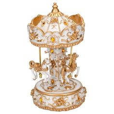 an ornate white and gold carousel with golden decorations on it's sides, isolated against a white background