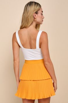 Celebrate the spring season with a cute new look like the Lulus Perfect Delight Light Orange Pleated Tiered Mini Skirt! Lightweight, cotton-blend pleated woven fabric shapes this totally adorable skirt that features a high, banded waist and a tiered, A-line silhouette that finishes at a flirty mini hem. Hidden side zipper/clasp. Fit: This garment fits true to size. Length: Mid-thigh. Size medium measures 16" from waist to hem. Waist: Fitted - very fitted at natural waist. Hip: Loosely Fitted. Fa Fitted Yellow Pleated Skort, Yellow Pleated Flared Mini Skirt, Relaxed Yellow Lined Mini Skirt, Yellow Cotton Pleated Mini Skirt, Retro Yellow Pleated Mini Skirt, Tiered Mini Skirt, Lulu Fashion, Spring Season, Side Zipper