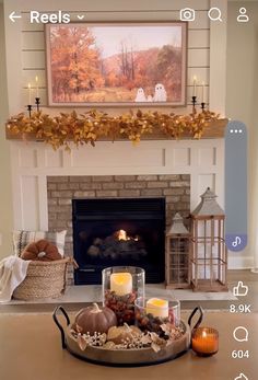 the fireplace is decorated with candles and other decorations in front of it, including pumpkins