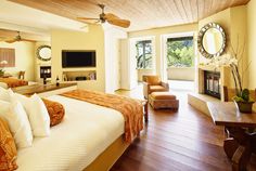 a large bed sitting inside of a bedroom on top of a hard wood floor