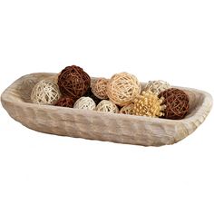 a wooden bowl filled with lots of different types of yarn balls on top of each other