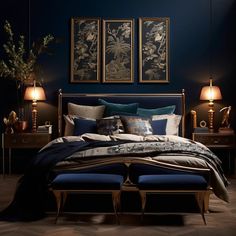 a bed with blue sheets and pillows in a room next to two pictures on the wall