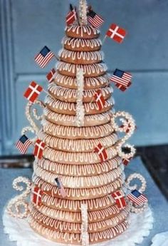 a christmas tree made out of cookies with flags on it's top and sides