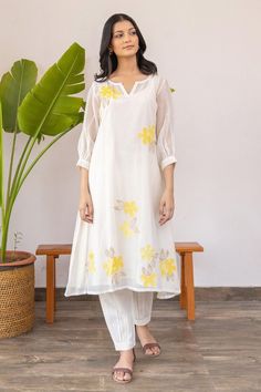 Buy off-white #chanderi #kurta with #yellow applique embroidered floral motifs on yoke by #KhamajIndia at #AzaFashions Shop online now at #Azafashions.com Call +91 8291990059 or email contactus@azafashions.com for enquiries. #wedding #festive #ethnic #tradional #shopping #shoponline #party Chanderi Kurta Designs, Silk Kurti Designs, Simple Frock Design, Pleated Pant