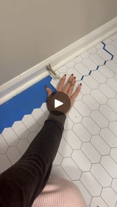 someone is painting the floor with blue tape