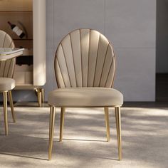 two beige chairs sitting next to each other on top of a carpeted floor in front of a white wall