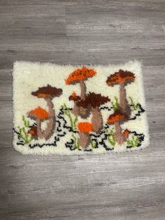 a rug with mushrooms on it is laying on the floor