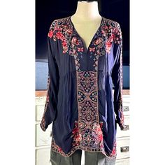 New With Tags Size Small This Beautiful Navy Tunic Is The Perfect Example Of Why Johnny Was Is Everyone’s Favorite Bohemian Designer. The Details Are Stunning And So Well Done. This Blouse Has Intricate Red, Light Blue, Pink, Beige And White Embroidery Covering The Entirety Of It. The Embroidery Includes Floral Designs Mixed With Mosaic Decorations And A Few Gorgeous Butterflies For A Touch Of Whimsy. It Is A Longsleeve Piece With A Flattering V-Neck. The Top Has Traditional Peasant Top Neck Ties. *There Is A Tiny Pulled Thread On One Sleeve As Shown In The Closeup Sleeve Picture. Measurements Laying Flat: Length 31” Bust 20” Bohemian Blue Embroidered Top With Geometric Patterns, Embroidered Rayon Bohemian Blouse, Blue Long Sleeve Top With Resham Embroidery, Blue Bohemian Top With Intricate Embroidery, Blue Bohemian Blouse With Geometric Embroidery, Bohemian Blue Blouse With Geometric Embroidery, Spring Blue Top With Resham Embroidery, Blue Floral Print Embroidered Top, Bohemian Blue Tops With Intricate Embroidery