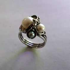 From Porans collection---> Fresh Water Pearls Ring,Unique Elegant,Romantic Ring, Perfect Christmas Gift Sterling silver ring with 3 pearls(1x3mm, 1x4mm, 1x6mm) Dimensions: Front Width(max):18 mm Back width(min): 4 mm Can be any size you want. Come in an exquisite jewelry box ready to be given away as a gift to your beloved ones or thyself. For Express shipping please purchase: https://www.etsy.com/il-en/listing/166710514/express-shipping? This will make a total fee of 30$ for postal costs and Elegant Stackable Sterling Silver Pearl Ring, Elegant Sterling Silver Stackable Pearl Ring, Silver Ring With Pearl Charm, Silver Akoya Pearl Drop Ring, Elegant Adjustable Wire Wrapped Pearl Ring, Silver Akoya Pearl Ring With Pearl Drop, Dainty Silver Pearl Drop Ring, Elegant White Handmade Stackable Rings, Elegant Stackable Rings With Pearl Drop For Gift