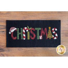 a black door mat with the word christmas on it