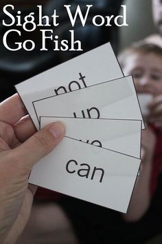 the sight word go fish game is being held up