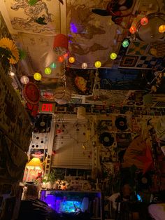 an overhead view of a room with lights and decorations on the ceiling, including posters