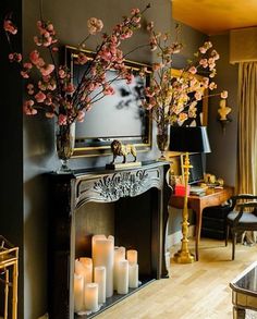 a living room filled with lots of furniture and flowers on top of a fire place